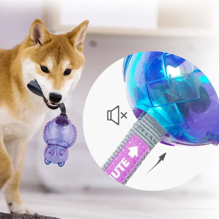 Shiba Inu dog carrying a purple and blue GiGwi Push-to-Mute squeaky toy with strap, shown with close-up of mute switch for quiet or squeaky play during travel